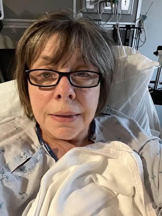 Breast cancer survivor Charlotte, in a hospital bed after surgery.