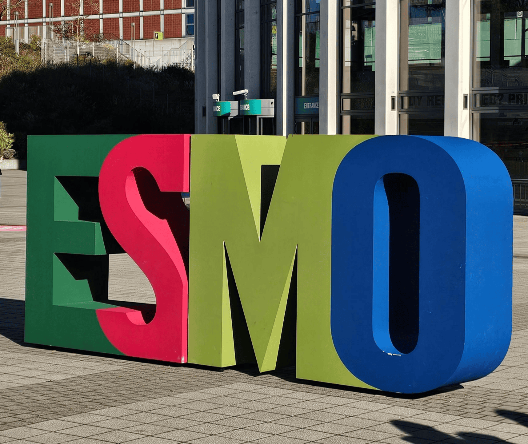 Colorful ESMO sign displayed in front of conference center