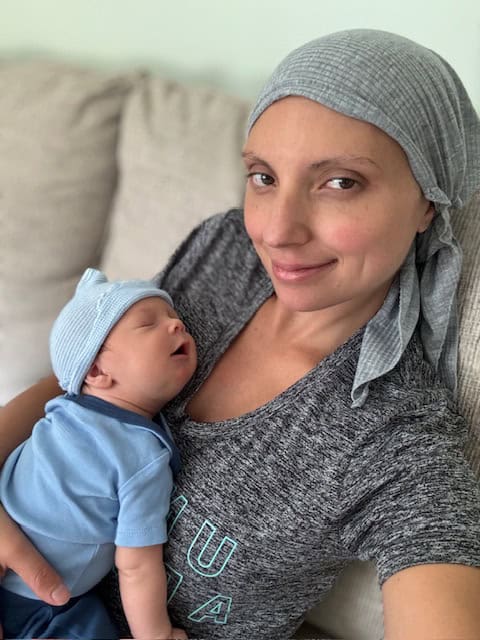 Breast cancer survivor Jenna and her newborn son.