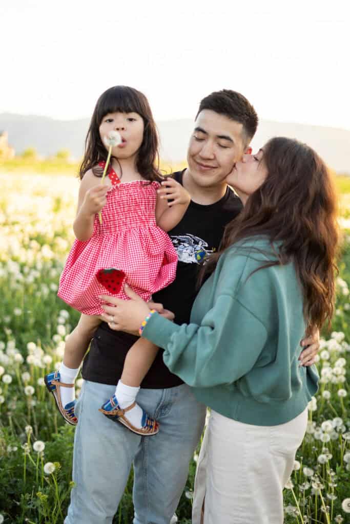 Breast cancer survivor Sara poses with her husband and daughter.