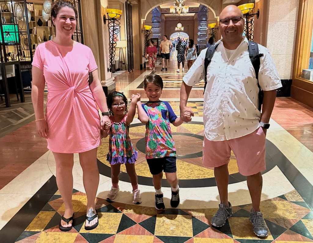 Breast cancer survivor Ashley smiles with her husband and two kids. 