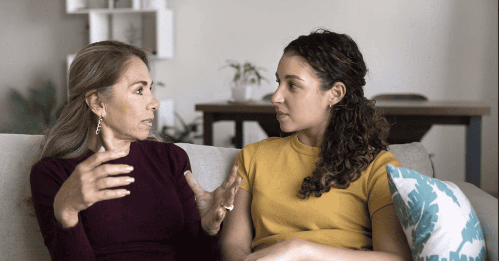 Two people, a patient navigator and breast cancer patient, talk.