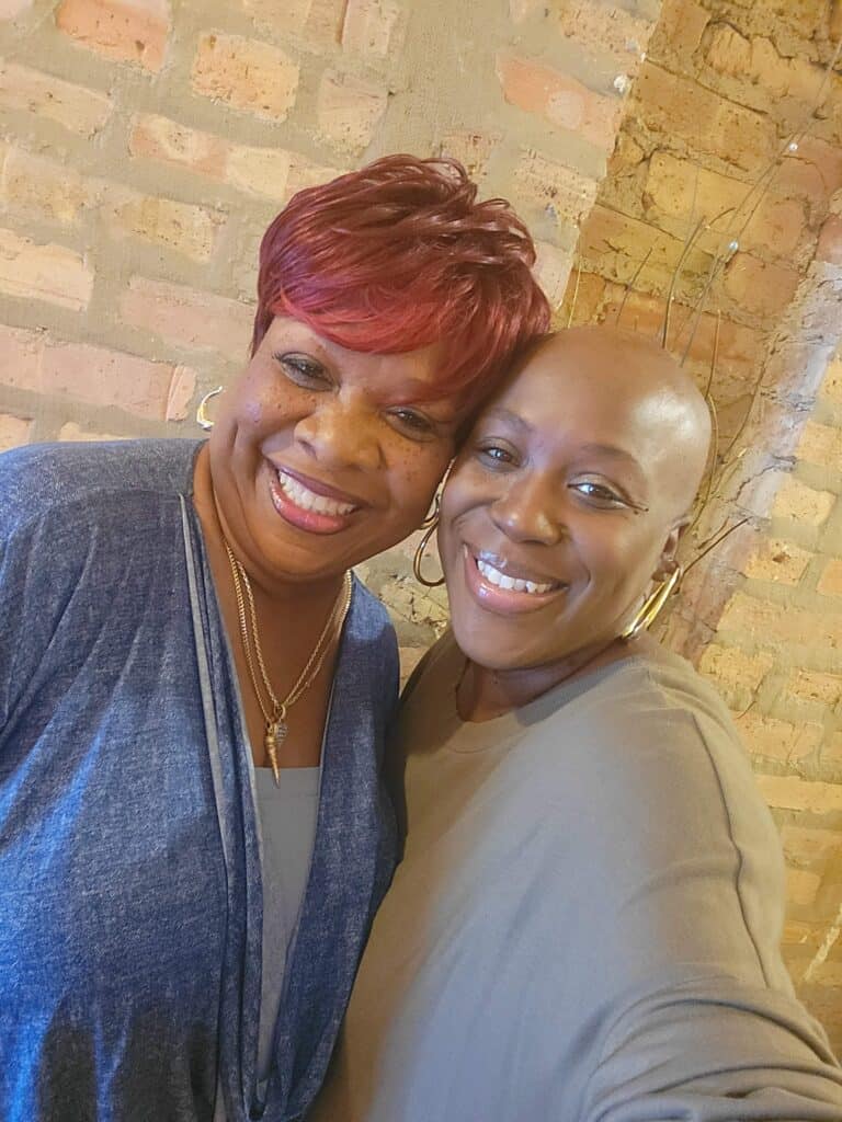 Tennille, living with metastatic breast cancer, and her mom smile at the camera. 