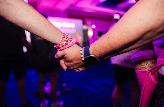Attendees at the 2026 Susan G. Komen Boston 3-Day holding hands at Opening Ceremony on Day 1.