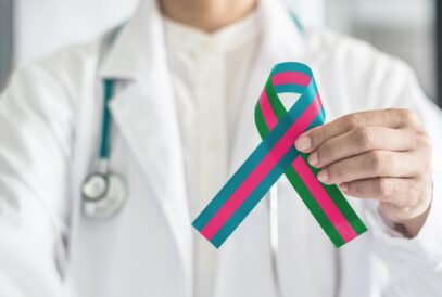 A doctor holds up a metastatic breast cancer ribbon.