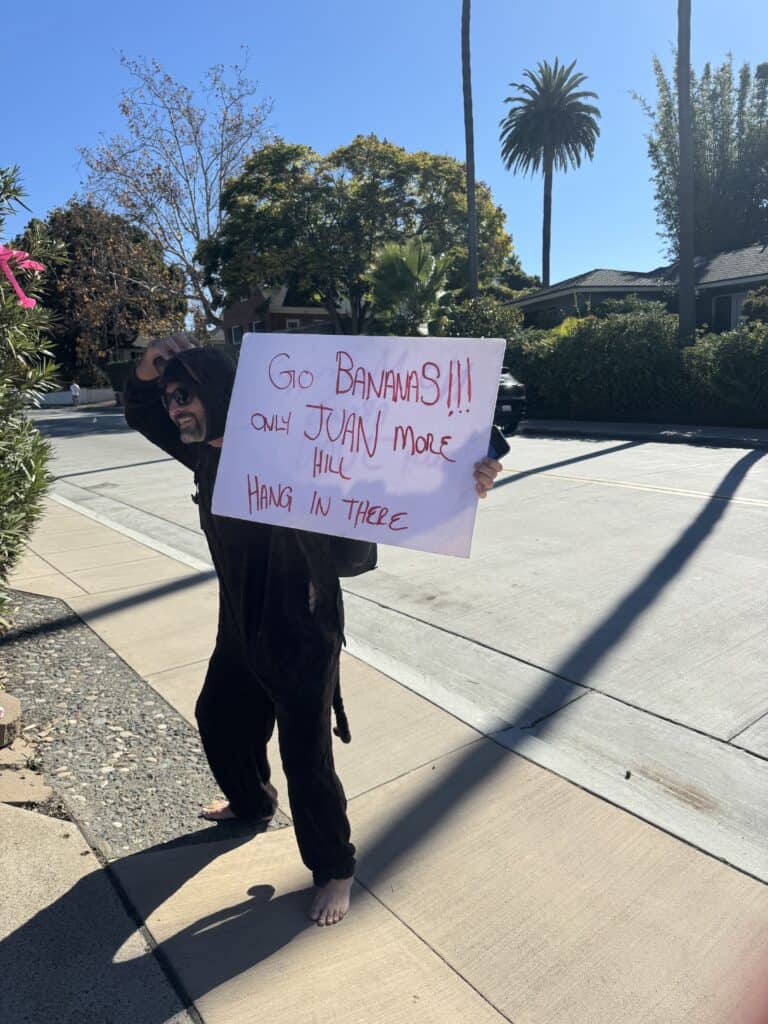 A neighbor on Juan Street in San Diego holding a sign to support the Komen 3-Day walkers.